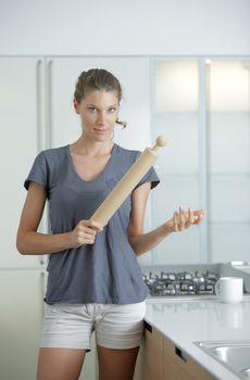 Angry housewife with rolling pin