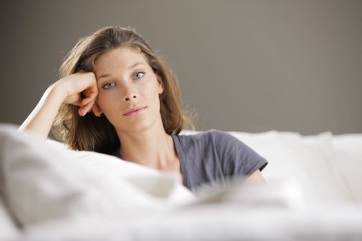 Portrait of beautiful young woman relaxing on couch 