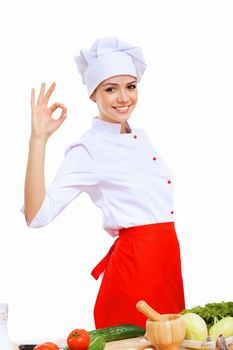 Young cook preparing food wearing a red apron