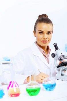 Young female scientist working with liquids in laboratory