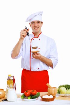 Young cook preparing food wearing a red apron