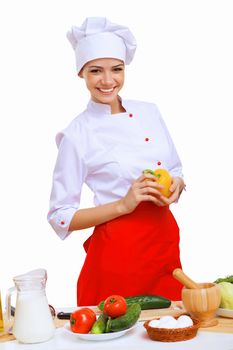 Young cook preparing food wearing apron on white background