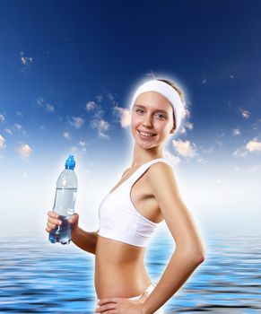 Portrait of a young woman doing sport with a bottle of pure water