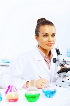 Young female scientist working with liquids in laboratory