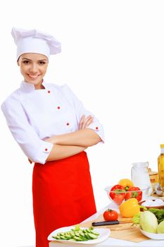 Young cook preparing food wearing red apron