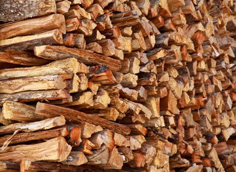 Dry firewood in a pile for furnace kindling