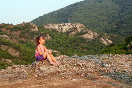 little girl looking at the mountain