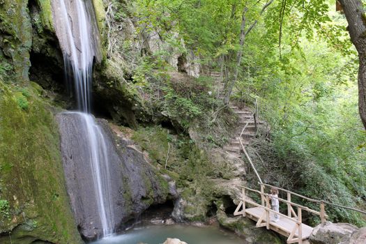 little girl looking at waterfall