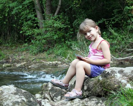 little girl posing with tablet