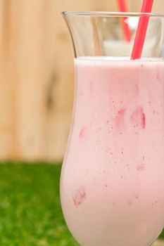 Strawberry milk shake with red straw