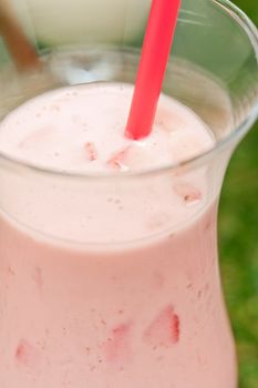 Strawberry milk shake with red straw