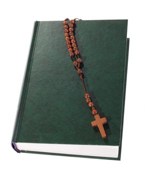 Wooden rosary on the Bible, isolated on white