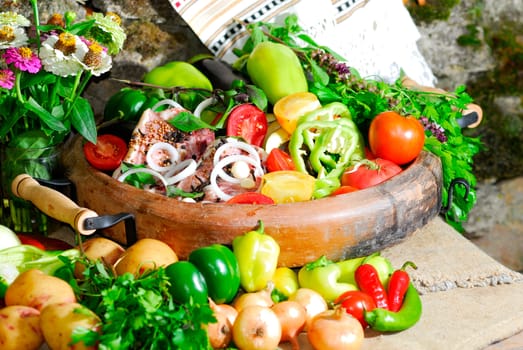 still life from vegetables and meat on the earthen dish in ethnic style