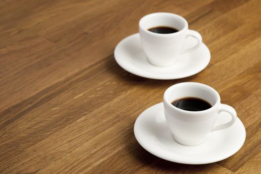 Two coffee cups on the table.