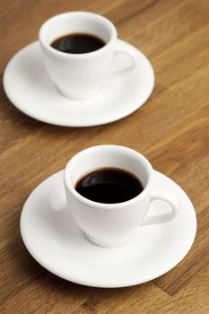 Two coffee cups on the table.