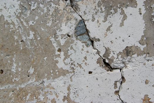 Texture of old weathered concrete wall with rusty warning stripes