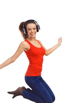 Happy smiling girl dancing and listening to music