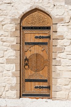 door with Arabic script in the stone wall