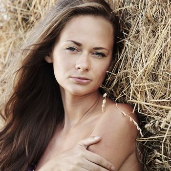 portrait of a girl next to haystack close
