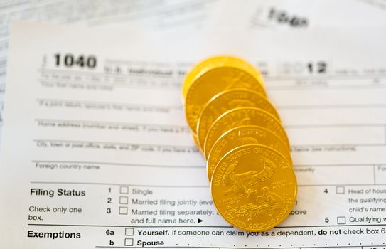 Tax form 1040 for tax year 2012 for US individual tax return with gold coins