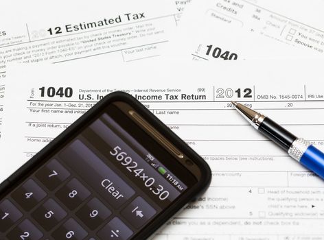 Tax form 1040 for tax year 2012 for US individual tax return with smartphone calculator