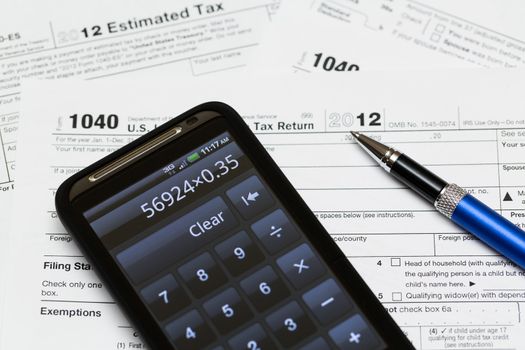 Tax form 1040 for tax year 2012 for US individual tax return with smartphone calculator
