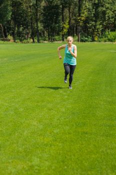 An active beautiful caucasian woman running outdoor in a park