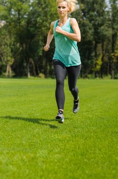 An active beautiful caucasian woman running outdoor in a park