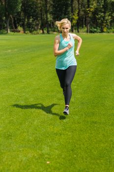 An active beautiful caucasian woman running outdoor in a park