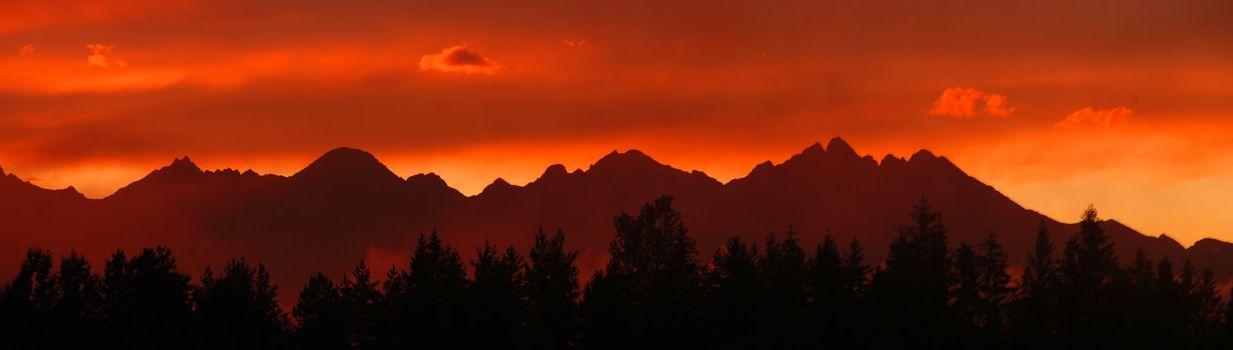 Panoramic photo of Tatras mountains in Slovakia after the storm in the evening at dusk