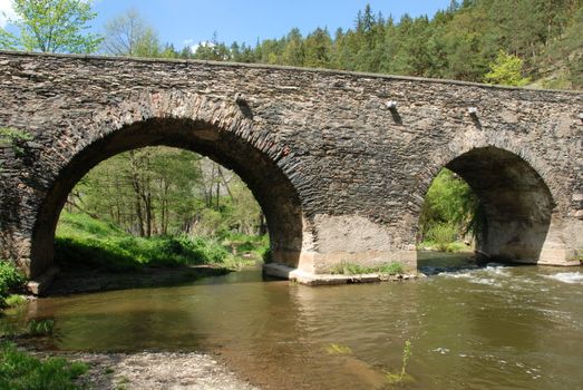   Ancient stone bridge over the river Strela in the Czech Republic        