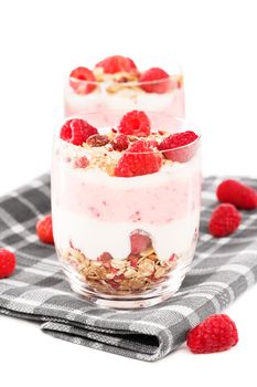 raspberry muesli dessert in front of another on a towel with white background