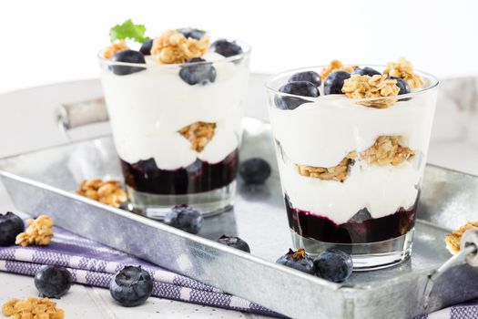 two blueberry yoghurt desserts from side on a metal tray