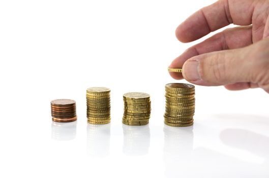 man putting euro coin on stack money