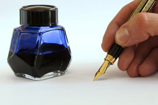 Human hand to write with a pen and ink to load