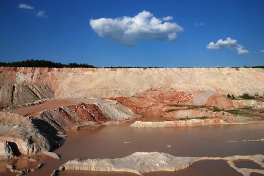 Old limestone quarry partially flooded with water