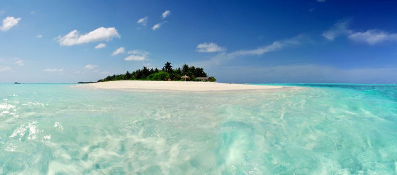 Beautiful Maldivian atoll with white beach seen from the sea.Panorama