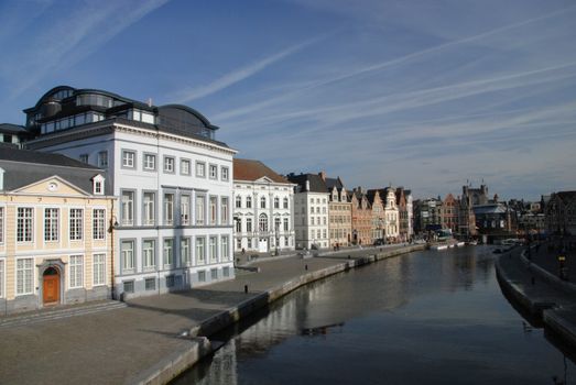 gabled houses along a canal in Gent, Belgium with reflection on the water 