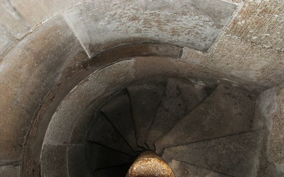 Ancient stairway in abandoned ruined castle tower leading to catacoms