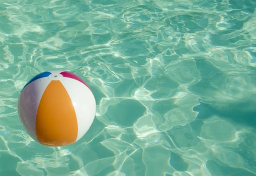 Ball in sparkling water in swimming pool