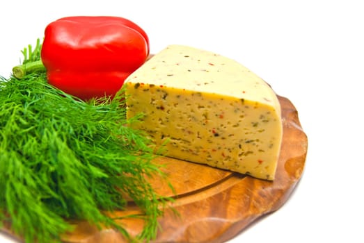 cheese with paprika and herbs on cutting board on white