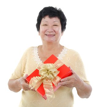 Happy mixed race Senior Asian woman holding a gift box and smiling