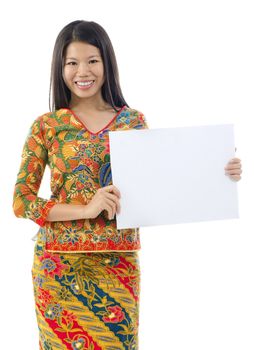 Asian woman in batik dress holding a placard over white background
