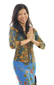 Southern Thai woman in a traditional welcoming gesture over white background