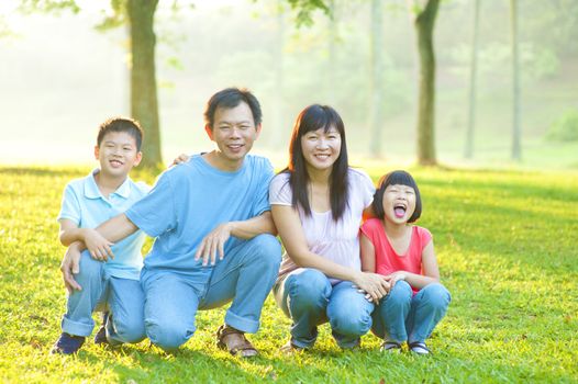 Happy Asian family in the park