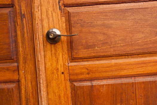 Wooden door with a knob.