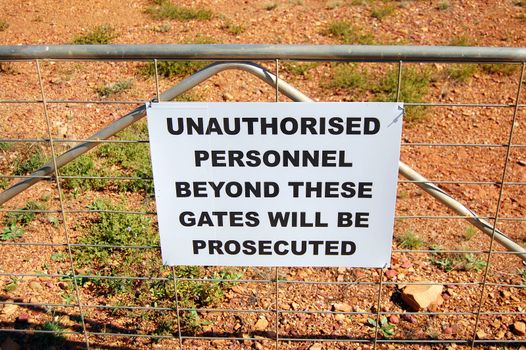 Warning sign on fence near mine in Cobar town, Australia