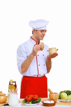 Young cook preparing food wearing a red apron