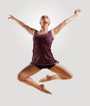 Girl dancing in a color dress with a gray background. isolate