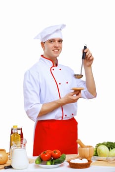 Young cook preparing food wearing a red apron